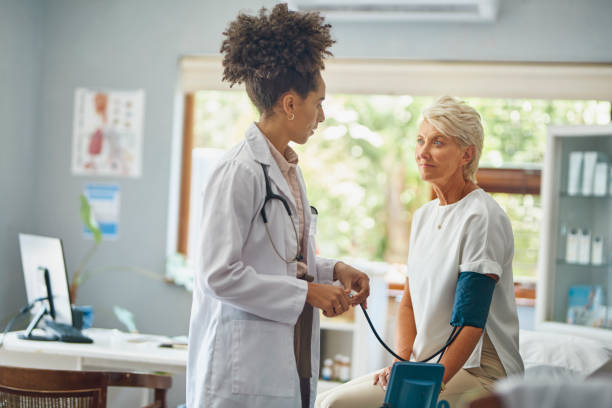Doctor checking a patient's blood pressure in a clinic